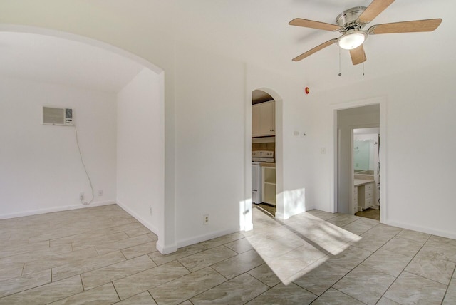 unfurnished room featuring a wall mounted AC, washer / clothes dryer, and ceiling fan