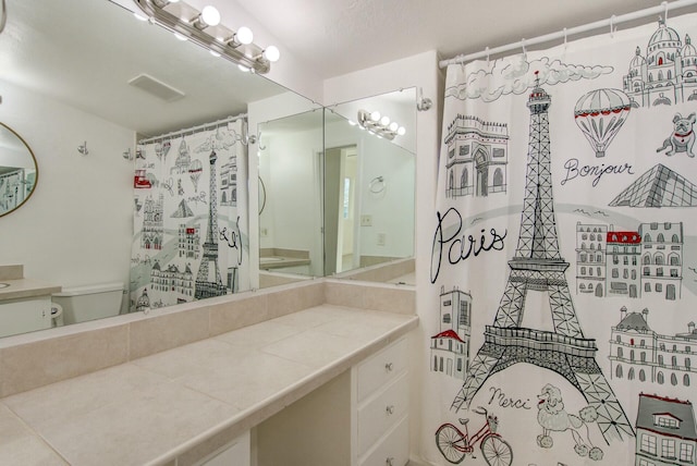 bathroom featuring vanity and toilet