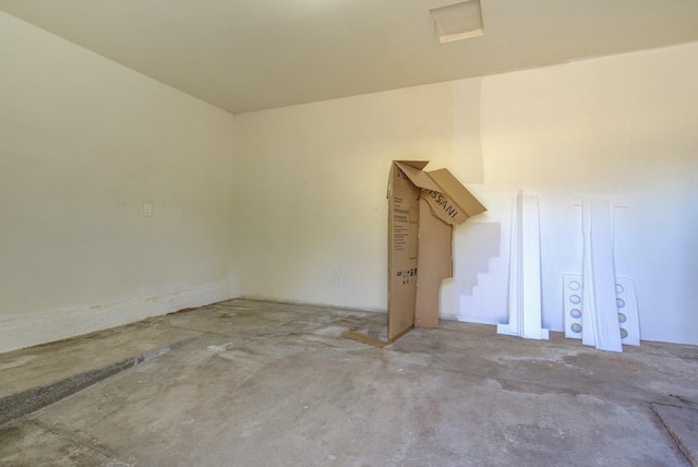 unfurnished room with concrete flooring