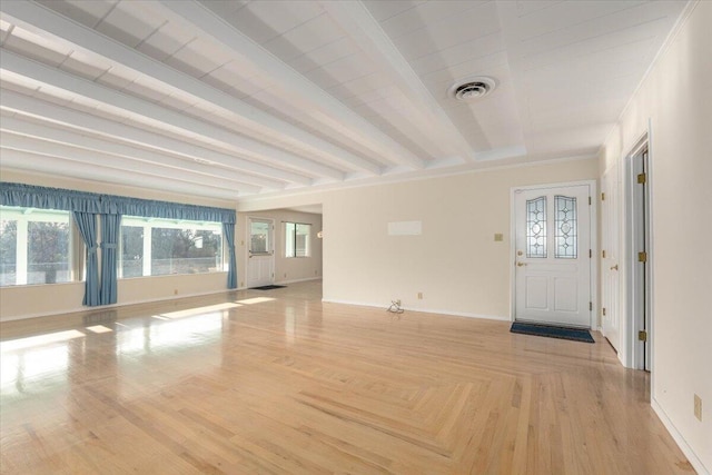 foyer featuring beamed ceiling, light wood-type flooring, and crown molding