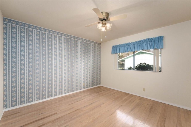 empty room featuring wood-type flooring and ceiling fan