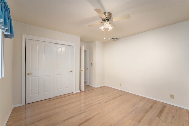 unfurnished bedroom with ceiling fan, a closet, and light hardwood / wood-style floors