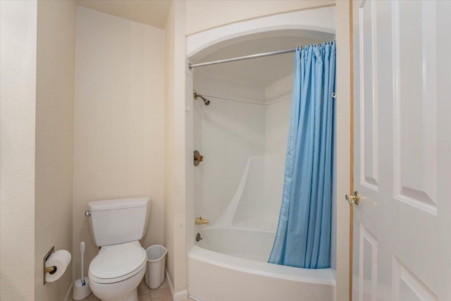 bathroom featuring shower / tub combo, toilet, and tile patterned floors