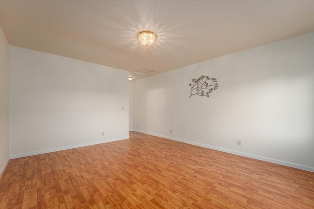 spare room featuring light hardwood / wood-style floors