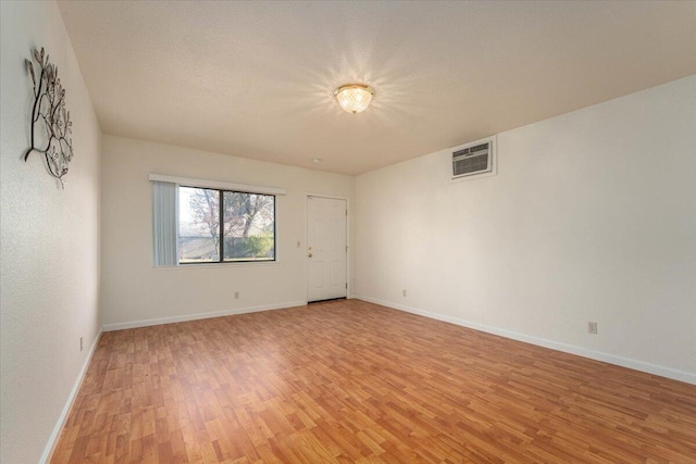 unfurnished room with light hardwood / wood-style floors