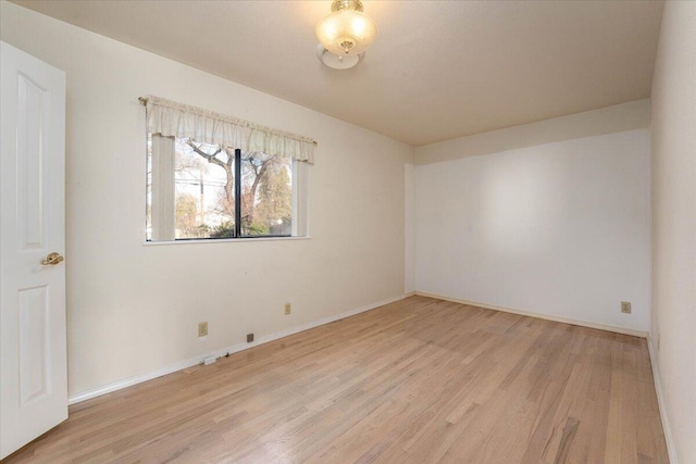 unfurnished room with light hardwood / wood-style floors