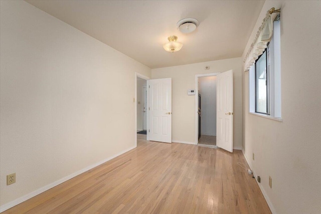 unfurnished bedroom with light wood-type flooring