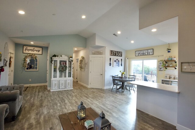 living room featuring hardwood / wood-style flooring and vaulted ceiling