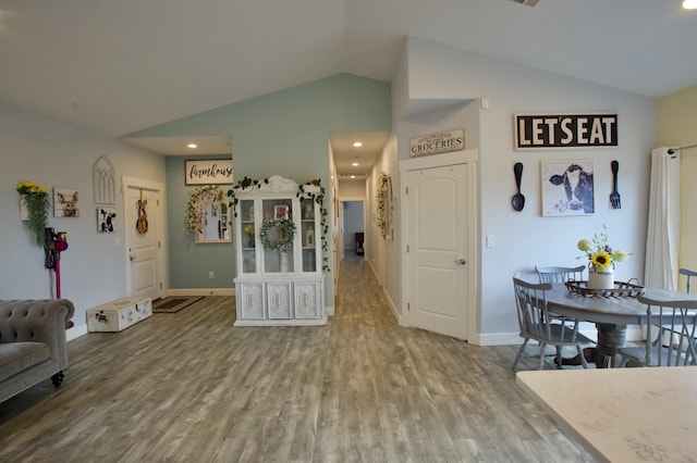 interior space featuring hardwood / wood-style flooring and vaulted ceiling