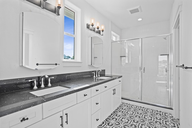 bathroom with vanity and a shower with shower door