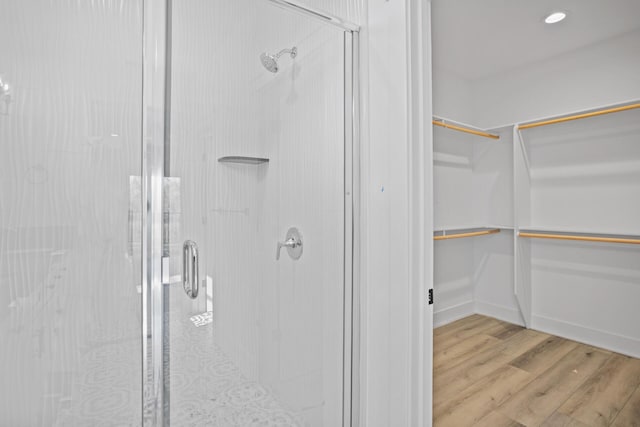 bathroom featuring hardwood / wood-style floors and an enclosed shower