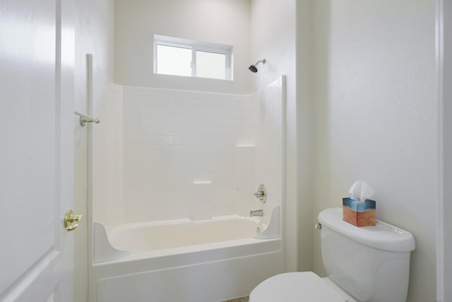 bathroom featuring shower / washtub combination and toilet