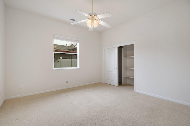 unfurnished bedroom with ceiling fan, a closet, and light carpet