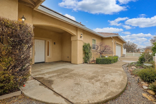 view of exterior entry featuring a garage