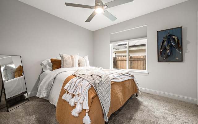 bedroom with ceiling fan and dark carpet