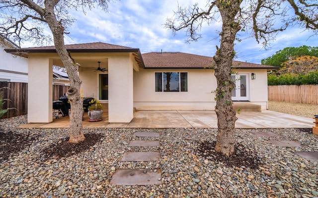 rear view of property with ceiling fan and a patio