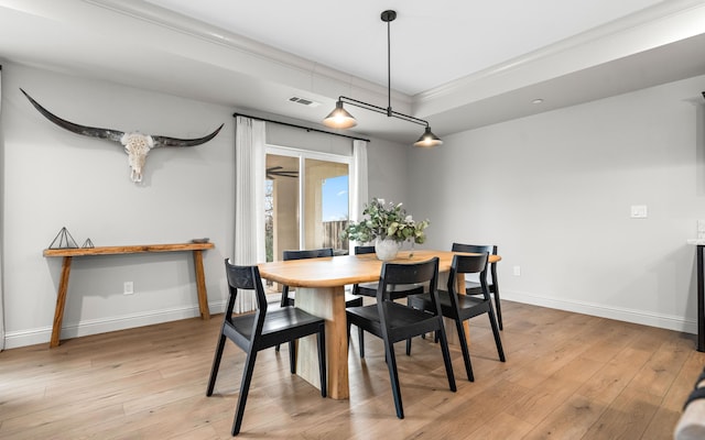 dining room featuring light wood-type flooring and ornamental molding