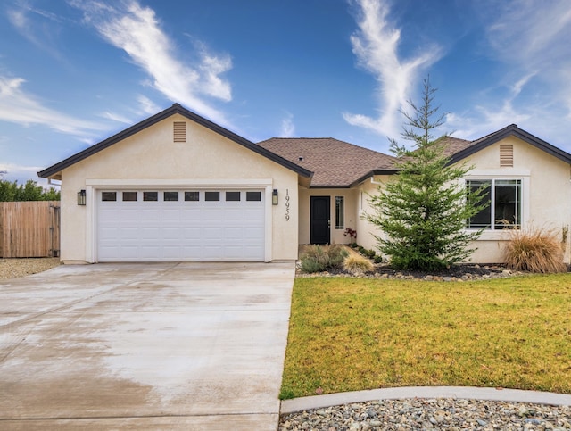 single story home featuring a garage and a front yard