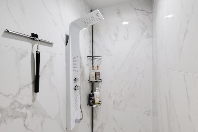 bathroom with a tile shower