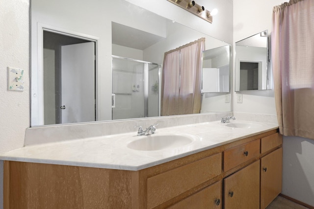 bathroom with vanity and a shower with shower door