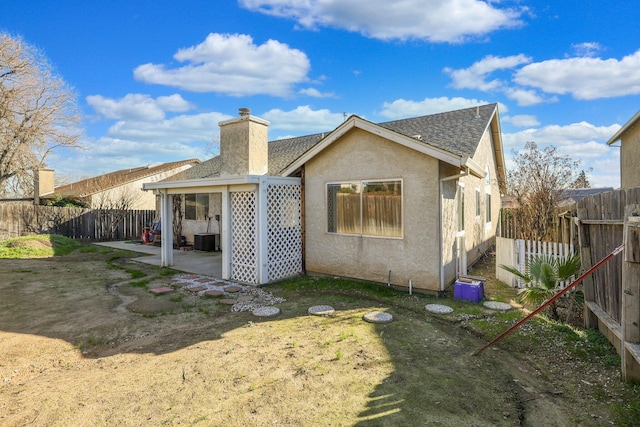 rear view of house featuring cooling unit and a patio