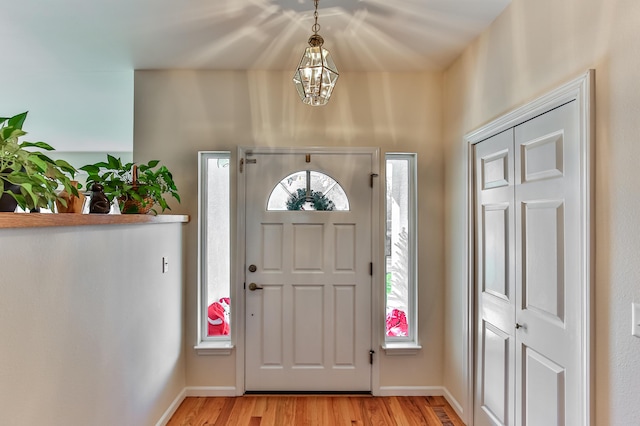 entrance foyer with a notable chandelier and light hardwood / wood-style floors