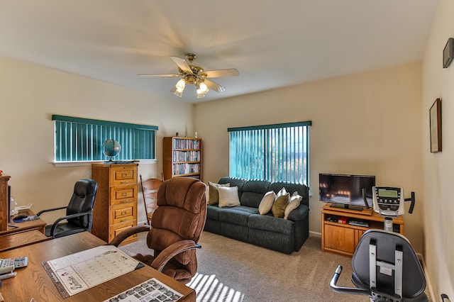 carpeted office space featuring ceiling fan