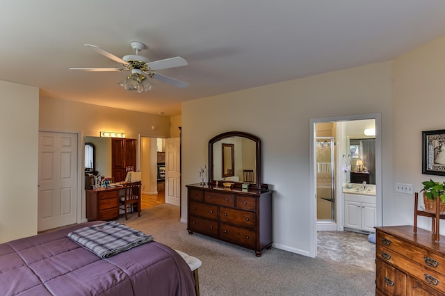 carpeted bedroom featuring ceiling fan and connected bathroom