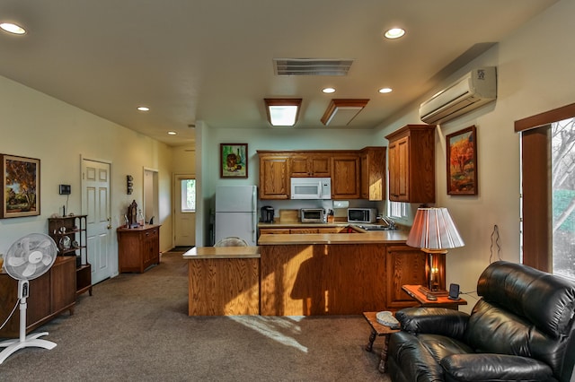 kitchen with kitchen peninsula, white appliances, sink, dark colored carpet, and an AC wall unit