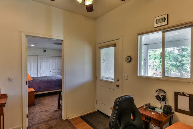 doorway to outside with carpet and ceiling fan