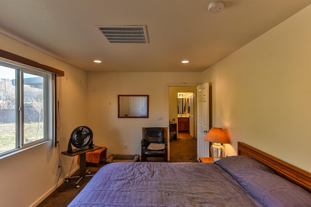 bedroom with multiple windows and dark carpet