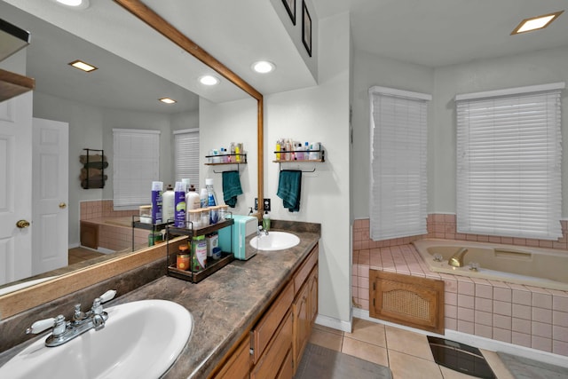 bathroom featuring tile patterned floors, vanity, and a relaxing tiled tub