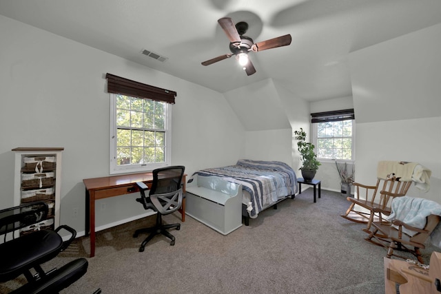 carpeted bedroom with multiple windows, ceiling fan, and vaulted ceiling