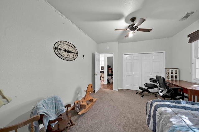 carpeted bedroom with a closet and ceiling fan