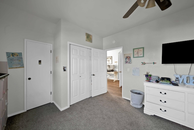 carpeted bedroom with ceiling fan and a closet