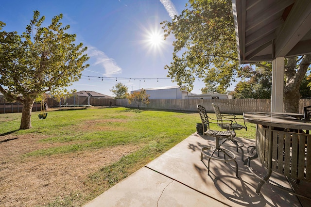 view of yard featuring a patio area and a trampoline