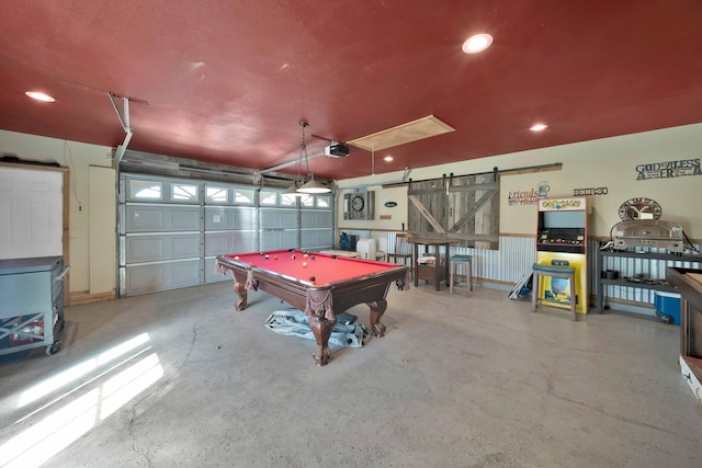 game room featuring a barn door, concrete floors, and pool table