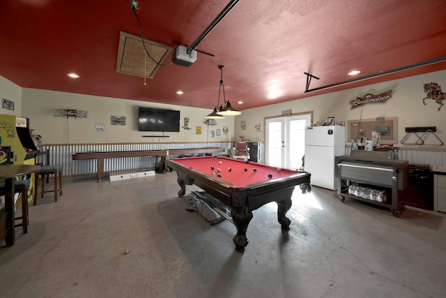 recreation room with concrete flooring, a textured ceiling, and pool table