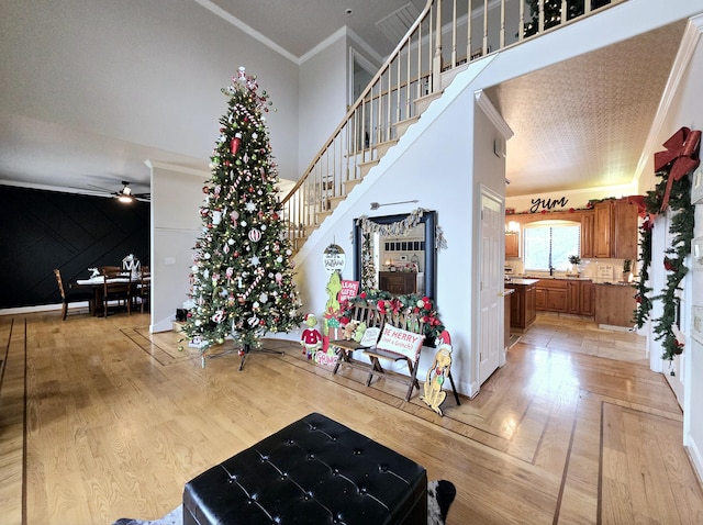 interior space featuring hardwood / wood-style flooring, ceiling fan, and ornamental molding