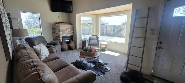 living room with a fireplace and carpet floors