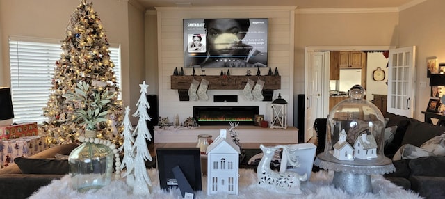 living room with ornamental molding and a fireplace