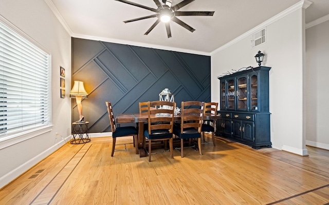 dining room featuring light hardwood / wood-style flooring, ceiling fan, and crown molding