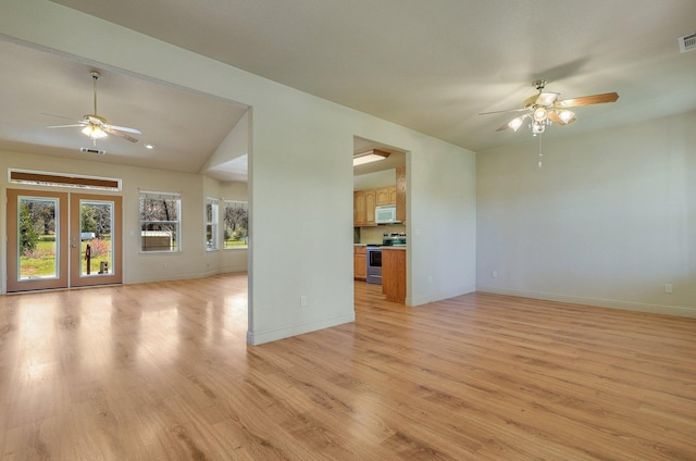 7899 Elmers Way, Shingletown, CA 96088 - unfurnished living room featuring a ceiling fan, light wood-style flooring, baseboards, lofted ceiling, and french doors