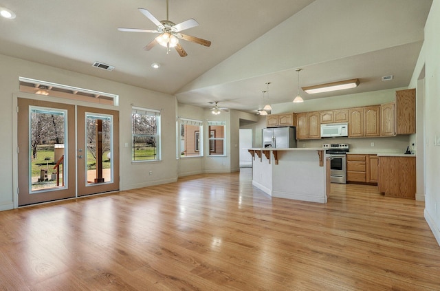 7899 Elmers Way, Shingletown, CA 96088 - kitchen with appliances with stainless steel finishes, a ceiling fan, french doors, open floor plan, and high vaulted ceiling
