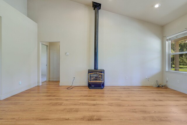7899 Elmers Way, Shingletown, CA 96088 - unfurnished living room with a wood stove, light wood-style flooring, recessed lighting, and baseboards