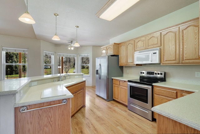 7899 Elmers Way, Shingletown, CA 96088 - kitchen featuring stainless steel appliances, a sink, light wood finished floors, an island with sink, and light countertops