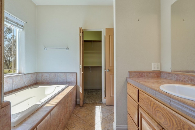7899 Elmers Way, Shingletown, CA 96088 - bathroom featuring a walk in closet, a tub with jets, and vanity