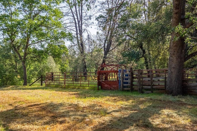 7899 Elmers Way, Shingletown, CA 96088 - view of yard featuring a gate, fence, and a wooded view