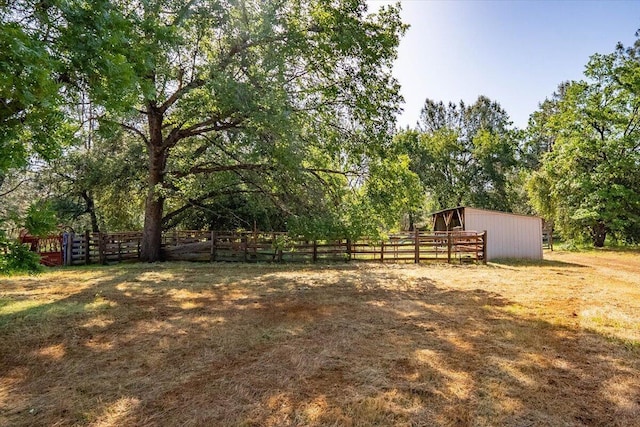 7899 Elmers Way, Shingletown, CA 96088 - view of yard featuring an outdoor structure, an exterior structure, and fence