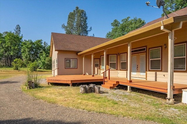 7899 Elmers Way, Shingletown, CA 96088 - view of front of property with french doors, roof with shingles, a deck, and a front yard